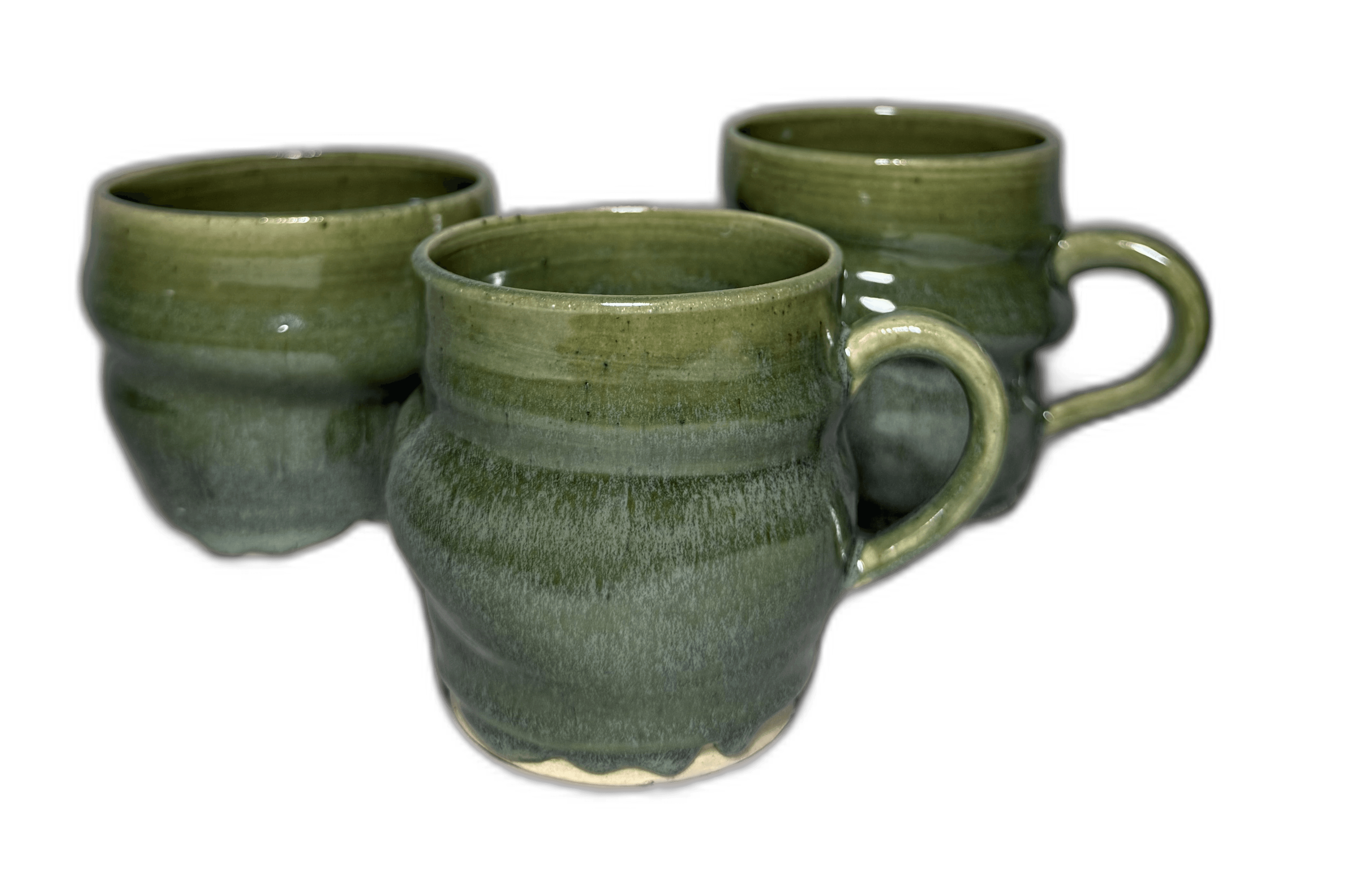 Stacked green-glazed mugs photographed for a journal cover