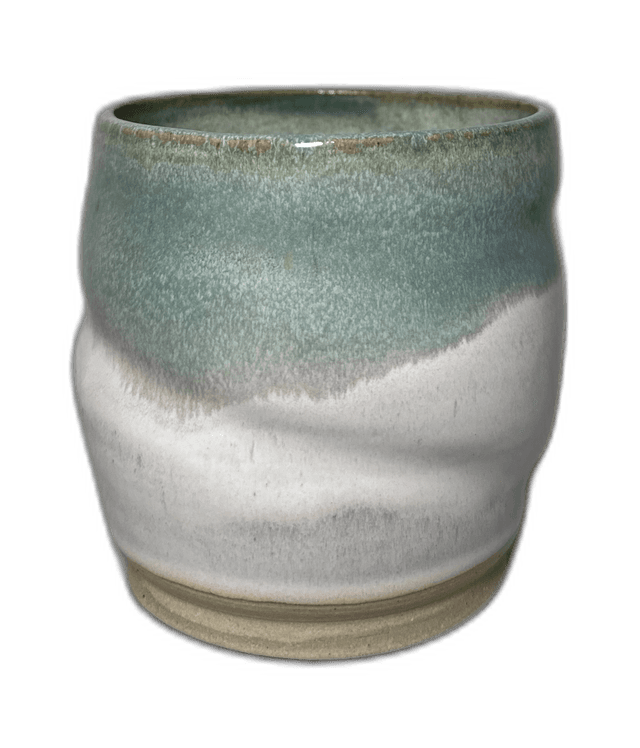 A mist-toned handmade mug photographed in the studio