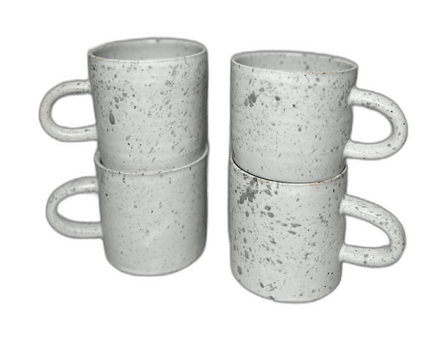 A second pair of speckled mugs photographed in the studio