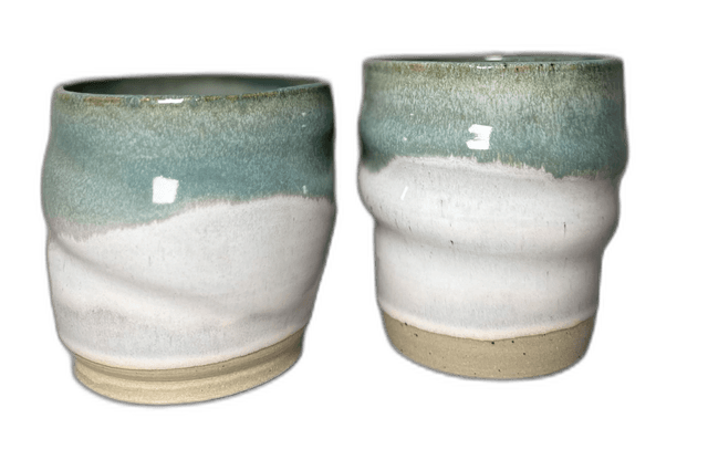 A pair of speckled mugs photographed in the studio