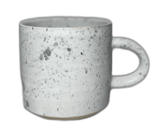 A speckled mug photographed in the studio