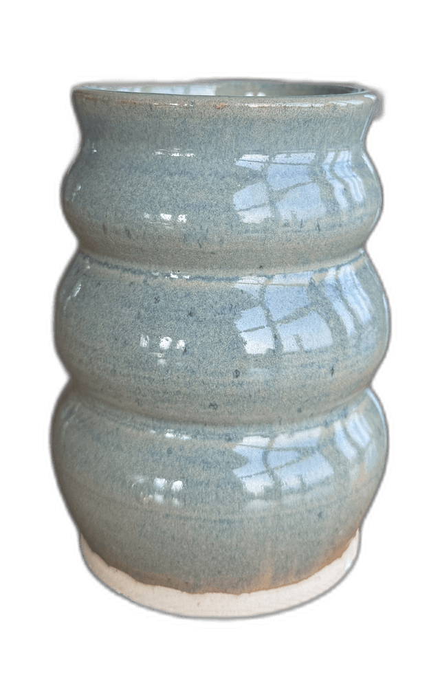 A sandstone bowl photographed in an outdoor studio setting