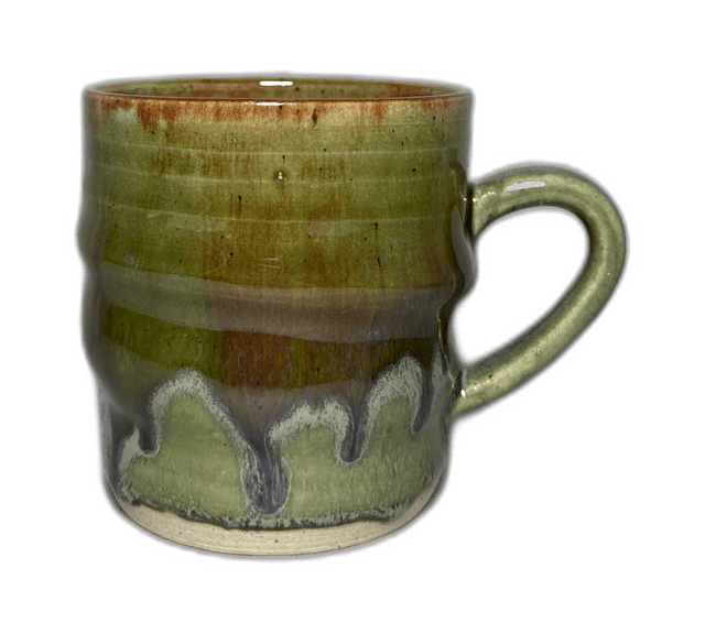 A second green-glazed mug photographed on a neutral backdrop