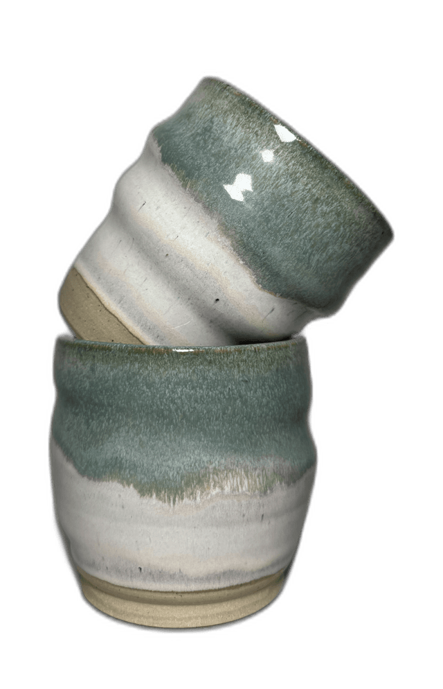 A mist-toned ceramic mug photographed in the studio