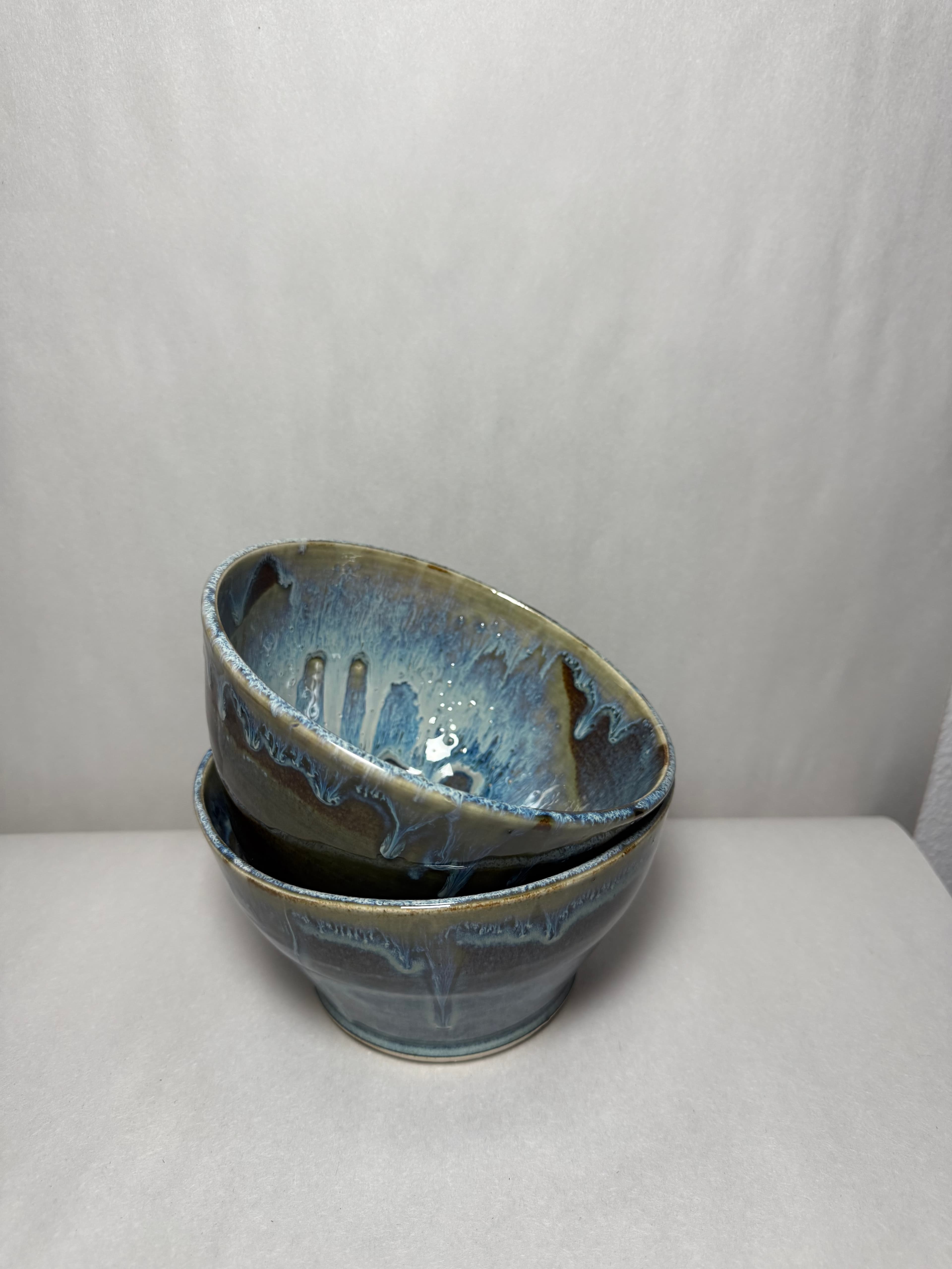An ochre-glazed tumbler with milky drip over stoneware