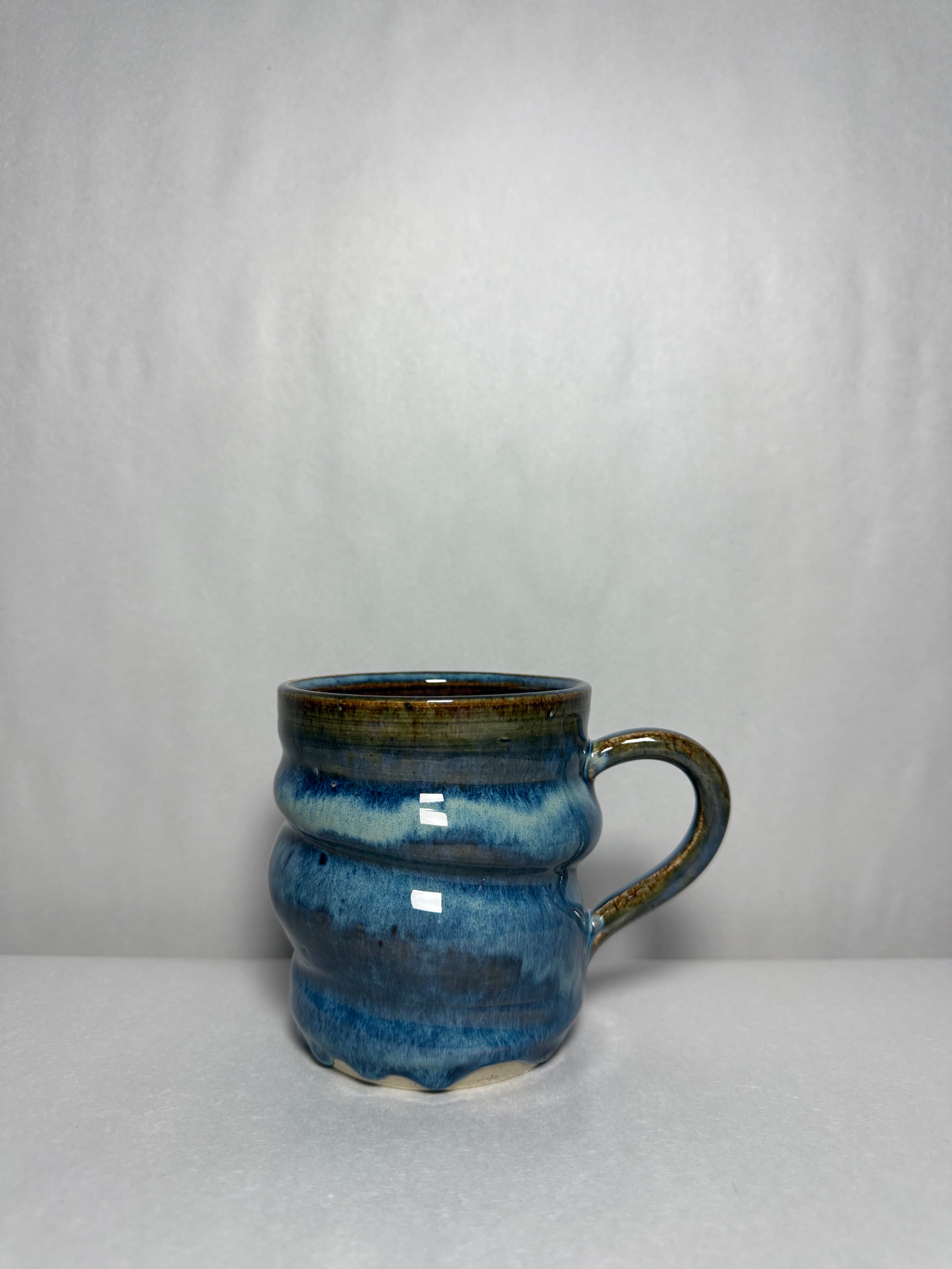 A pair of blue crystalline bowls photographed together