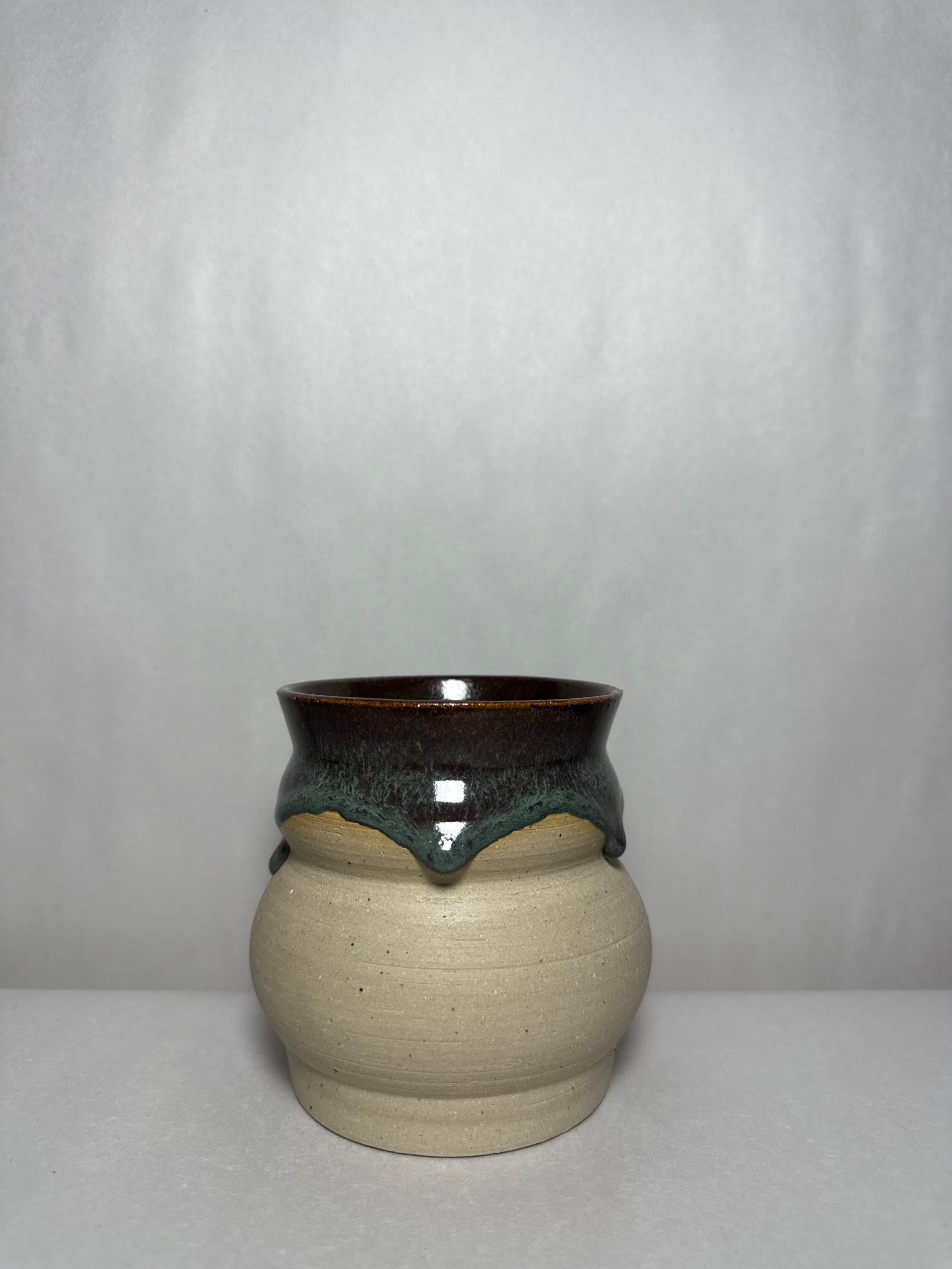 A shelf of studio vessels photographed in natural light