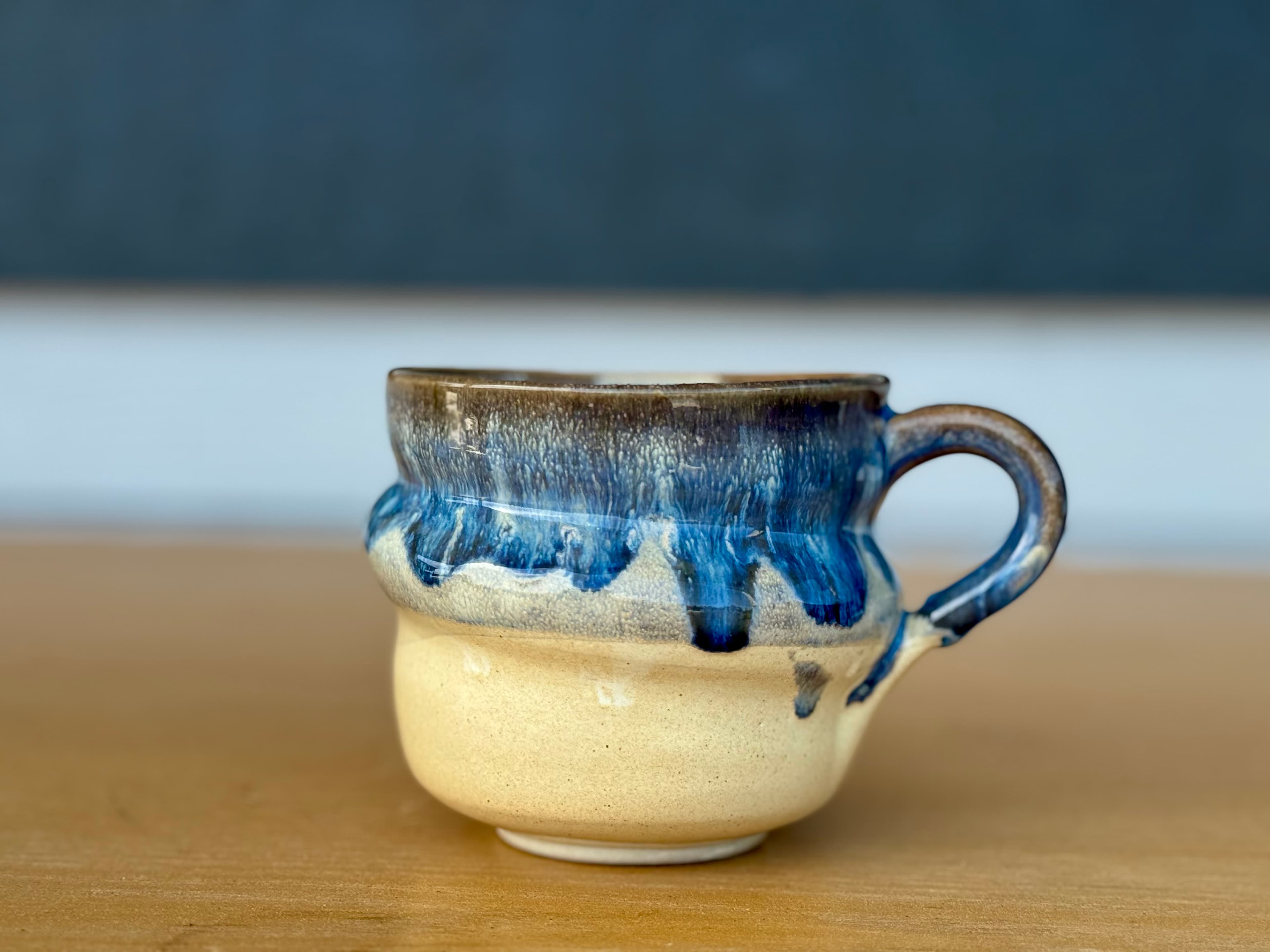 A handmade mug in warm window light at Solan Studios